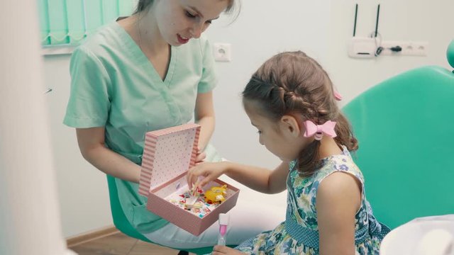 children's dentist entertains little girl