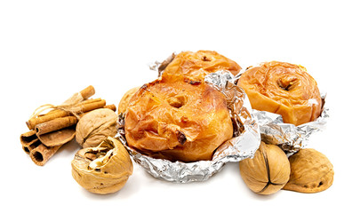 Baked apples with walnuts and cinnamon isolated on white