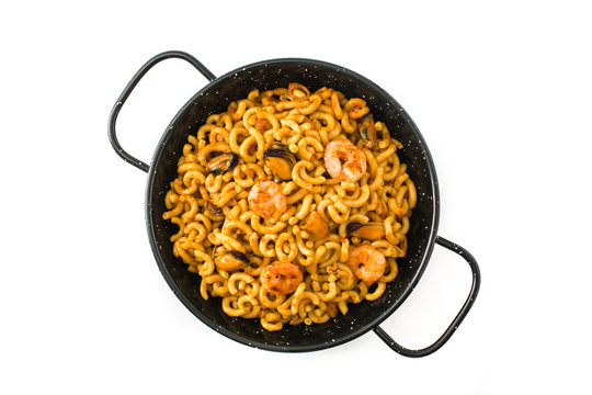 Traditional Spanish fideua. Noodle paella isolated on white background. Top view