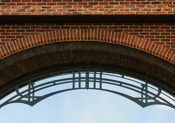 Top part of brick arch with forged decorations