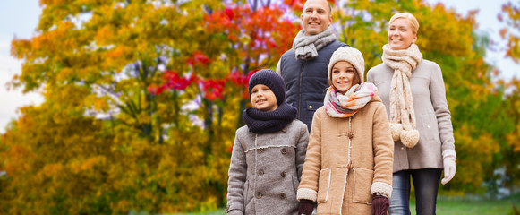 family, season and people concept - happy mother, father, daughter and son over autumn park background