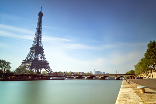 Long exposure of the Eiffel tower at the Seine in Paris in spring