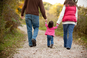 Young Family Walking Together on Autumn Trail