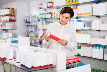 Female is browsing rows of body care products