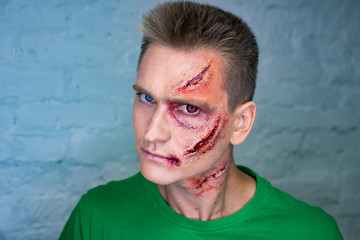 Professional make-up of young man with horrible scars
