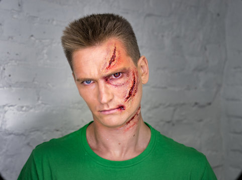 Professional make-up of young man with horrible scars