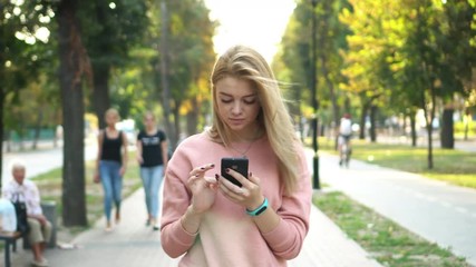 girl is using smartphone on street