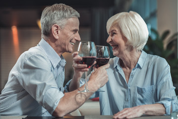 Our celebration. Happy female person expressing positivity while sitting near her man, keeping smile on face