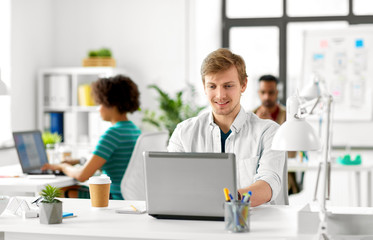 business and creative people concept - male office worker with laptop computer networking