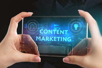 The concept of business, technology, the Internet and the network. A young entrepreneur working on a virtual screen of the future and sees the inscription: Content marketing