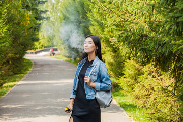 girl asian smokes wise. Harm to health. Smoking