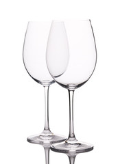 Two empty wine glasses on white background
