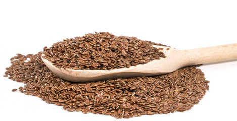 spoon with seeds of lien on white background