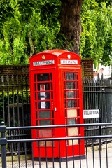 Fototapeta na wymiar Traditional red English telephone booth at King William Walk street. Greenwich. UK