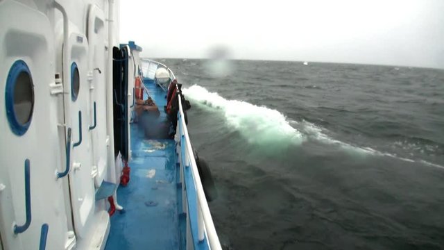 View from window on ship deck in storm and rain in bad weather on Lake Baikal. No person. Magic and wind power of cyclone in meteorology.