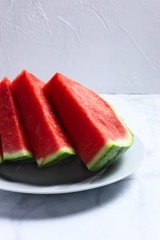 Slices of red water melon on a white plate