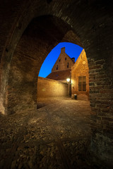 The entrance through an authentic monumental city gate to a characteristic medieval town. Remains of a historic old fortified town in the Netherlands 
