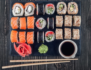 Various sushi rolls on slate