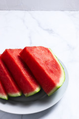 Slices of red water melon on a white plate