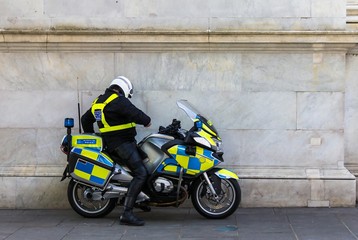 Unrecognizable policeman on the motorbike, on the street near Marble Arch underground station