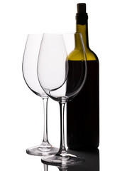 Red wine bottle with two empty glasses