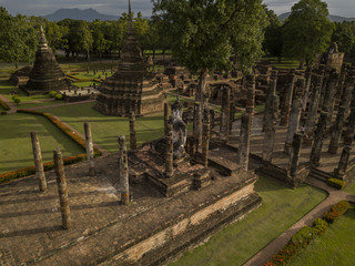 Aerial View of a historical sites ruins Buddhist Temple Wat Mahathat at The Sukhothai Historical Park, a registered UNESCO World Heritage City in the tranquil late afternoon sun