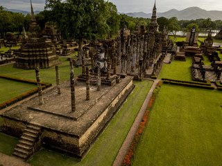 Aerial View of a historical sites ruins Buddhist Temple Wat Mahathat at The Sukhothai Historical Park, a registered UNESCO World Heritage City in the tranquil late afternoon sun