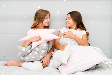 Girls children on bed with cute pillows. Pajamas party concept. Girls just want to have fun....