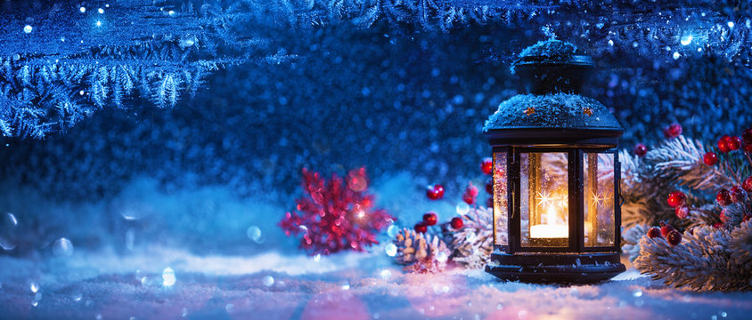 Winter Decoration with a Candlestick Near the Snow-Covered Window. Christmas Background