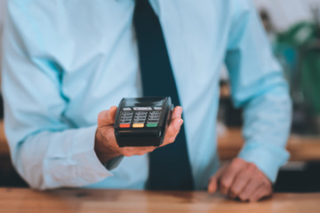 Type your pass. Professional businessman standing near his table and doing financial operation