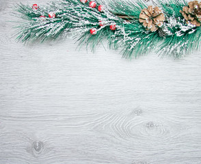 Christmas and New Year's composition. The pine cones, spruce branches on a wooden white background, top view