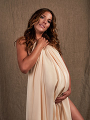 Fototapeta premium Young beautiful smiling pregnant woman. Happy Maternity concept