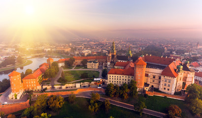 Fototapeta premium Aerial view Royal Wawel Castle and Gothic Cathedral in Cracow, Poland, with Renaissance Sigismund Chapel with golden dome, fortified walls, yard, park and tourists.