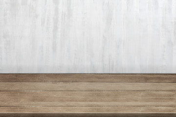 Empty wooden desk table near a textured wall