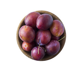 Bowl with plums isolated on white background. Ripe plums with copy space for text. Top view