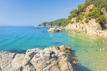 Lloret de Mar, Costa Brava, Spain - august 23, 2018: Cala Sa Boadella platja beach wit tourists on sunny clear summer day