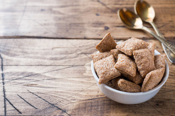Cookies crackers square shape in a plate on a wooden table. Copy space