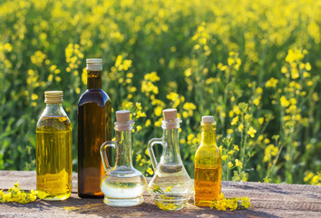rapeseed oil on wooden table in field