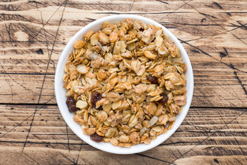 Healthy Breakfast homemade baked muesli on a wooden table.