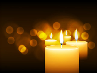 burning candles with gold bokeh
