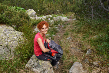 Naklejka na ściany i meble Hiker lady resting by the trail