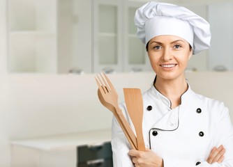 Portrait of young woman chef on white