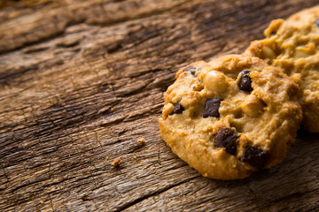 Chocolate chip cookies on rustic wood background.  Sweet biscuits. Homemade pastry