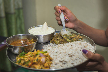 Nepali Hindu Woman having Dar or heavy Meal set on the Plate.Nepali Snacks Set.Khaja Set