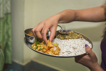 Nepali Hindu Woman having Dar or heavy Meal set on the Plate.Nepali Snacks Set.Khaja Set