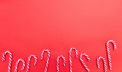 Candy canes on red background, copy space