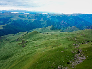 Fototapeta na wymiar View from the drone from the air. The landscape of the valley from a plateau Bermamyt the North Caucasus at sunrise.