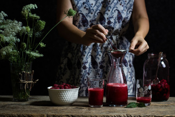 Fresh homemade raspberry juice. Process of making 100% pure organic fruit drink. Healthy lifestyle