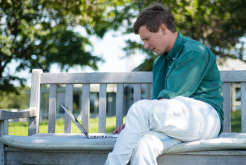 Obraz premium Man on Computer in Park