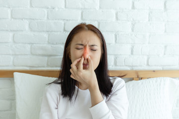 Asian young Woman have a Nasal pain after wake up in the morning,Healthcare Concept